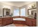 Relaxing bathroom with double sinks, a large soaking tub, and tile flooring at 17159 E Rand Dr, Fountain Hills, AZ 85268