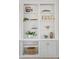 Built-in white shelving unit with decorative items and books at 3346 E Coconino Dr, Gilbert, AZ 85298