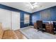 Bedroom with a dark wood desk and seating area, and blue walls at 19049 N 5Th Ave, Phoenix, AZ 85027