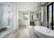 Spa-like bath includes a large soaking tub, walk-in shower, and marble finishes at 20958 N 112Th St, Scottsdale, AZ 85255
