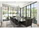 Modern dining room with large windows, a long table, and designer chairs at 20958 N 112Th St, Scottsdale, AZ 85255