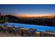 Infinity pool with mountain and city views at sunset at 20958 N 112Th St, Scottsdale, AZ 85255