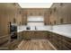 Modern kitchen features wood cabinetry, marble countertops, and top-of-the-line appliances at 20958 N 112Th St, Scottsdale, AZ 85255