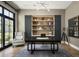 Stylish home office featuring built-in shelving and a large desk at 20958 N 112Th St, Scottsdale, AZ 85255
