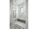 Spacious shower with marble tile and built-in bench at 20958 N 112Th St, Scottsdale, AZ 85255