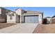 Single-story home with a gray garage door and stone accents at 7422 W Whitehorn Trl, Peoria, AZ 85383