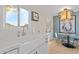 Modern kitchen with white cabinets, farmhouse sink, and stylish light fixture at 4620 N 68Th St # 136, Scottsdale, AZ 85251