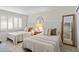 Cozy bedroom with twin beds, soft linens, and a full-length mirror at 4620 N 68Th St # 136, Scottsdale, AZ 85251