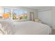 Spacious bedroom with a queen bed, chair, and window with plantation shutters at 4620 N 68Th St # 136, Scottsdale, AZ 85251