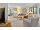 Living room with a brown leather sofa, armchairs, and a large TV at 4620 N 68Th St # 136, Scottsdale, AZ 85251