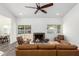 Bright and airy living room with a fireplace and sliding doors to the backyard at 15274 N 63Rd Ln, Glendale, AZ 85306