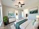 Bright and airy bedroom with ceiling fan and ensuite bathroom with double doors at 1716 W Lucky Ln, Queen Creek, AZ 85144