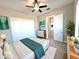 Bedroom with ceiling fan, ensuite bathroom access, double closet doors, and neutral decor at 1716 W Lucky Ln, Queen Creek, AZ 85144