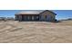 House rear view, showcasing a covered patio and desert landscape at 1716 W Lucky Ln, Queen Creek, AZ 85144