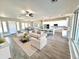 Open-concept living room and kitchen with white cabinets, large island, and dining area at 1716 W Lucky Ln, Queen Creek, AZ 85144