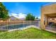 Sunny backyard with a sparkling pool and grassy area at 4341 E Abraham Ln, Phoenix, AZ 85050