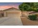 Two-car garage and well-manicured landscaping at 44102 W Venture Ln, Maricopa, AZ 85139