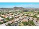 Aerial view of a residential neighborhood with parks and mountains in the background at 23014 N 22Nd Pl, Phoenix, AZ 85024