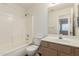 Clean bathroom with tub, toilet and vanity with wood cabinets at 2046 S Warren --, Mesa, AZ 85209