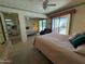 Bedroom with queen bed, mirrored closet, and access to patio at 3927 N Indiana Ave, Florence, AZ 85132