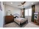 Charming bedroom with a floral comforter and vintage dresser at 6732 W Coles Rd, Laveen, AZ 85339