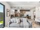 Modern living room features a gray sofa and access to the kitchen with a large island at 377 E Windsor Ave # 21, Phoenix, AZ 85004