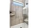 Walk-in shower with gray tile and built-in shelf at 377 E Windsor Ave # 21, Phoenix, AZ 85004