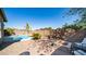 Landscaped backyard oasis featuring a pool and fire pit at 29031 N 69Th Dr, Peoria, AZ 85383