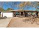 Single story home with a two car garage and mature tree at 748 S Rico Cir, Mesa, AZ 85204