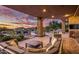 Large patio with fireplace, seating, and sunset views at 10792 E Sundance Trl, Scottsdale, AZ 85262