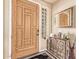 Entryway with wood door, glass block sidelight, and decorative console table at 13506 W Earll Dr, Avondale, AZ 85392