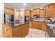 Modern kitchen with an island, stainless steel appliances, and wood cabinets at 13506 W Earll Dr, Avondale, AZ 85392