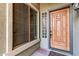 Inviting entryway with a wood door, glass block window, and decorative rug at 13506 W Earll Dr, Avondale, AZ 85392