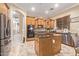 Modern kitchen with an island, stainless steel appliances, and wood cabinets at 13506 W Earll Dr, Avondale, AZ 85392