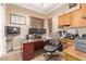 Bright home office features built-in cabinetry and desk at 13506 W Earll Dr, Avondale, AZ 85392