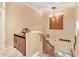 Upstairs hallway with built-in storage and staircase at 13506 W Earll Dr, Avondale, AZ 85392