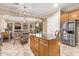 Open kitchen with an island, stainless steel appliances, and wood cabinets at 13506 W Earll Dr, Avondale, AZ 85392