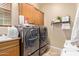 Laundry room with washer, dryer, and ample storage at 13506 W Earll Dr, Avondale, AZ 85392