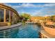 Inviting pool area with spa, fire pit, and mountain views at 42121 N Anthem Creek Dr, Anthem, AZ 85086