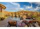 Luxury pool with patio furniture and mountain views at 42121 N Anthem Creek Dr, Anthem, AZ 85086