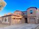 Two story home with a three car garage and desert landscaping at 15685 W Mackenzie Dr, Goodyear, AZ 85395