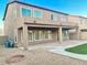 Covered patio, grassy area and gravel landscaping at 15685 W Mackenzie Dr, Goodyear, AZ 85395
