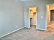 Bedroom with walk-in closet and neutral wall colors at 15685 W Mackenzie Dr, Goodyear, AZ 85395