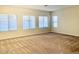 Bright and spacious living room with large windows and neutral carpet at 15685 W Mackenzie Dr, Goodyear, AZ 85395