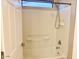 Clean bathroom with shower/tub combo and white tile at 15685 W Mackenzie Dr, Goodyear, AZ 85395