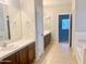 Bathroom boasts double sinks and a soaking tub at 15685 W Mackenzie Dr, Goodyear, AZ 85395