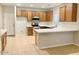 Modern kitchen with wood cabinets and quartz countertops at 15685 W Mackenzie Dr, Goodyear, AZ 85395