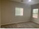Well-lit bedroom with neutral walls and carpet at 15685 W Mackenzie Dr, Goodyear, AZ 85395