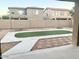 Artificial turf backyard with concrete patio and block wall at 15685 W Mackenzie Dr, Goodyear, AZ 85395