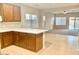 Kitchen features wood cabinets and a breakfast bar at 15685 W Mackenzie Dr, Goodyear, AZ 85395